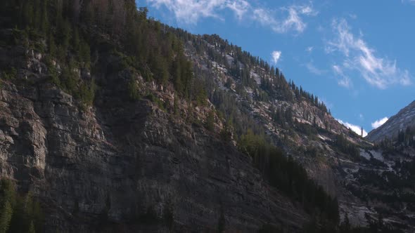 Aerial view of a beautiful mountainside and snowy cliffs in Utah.