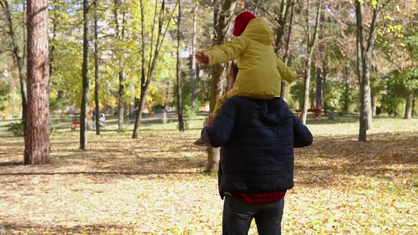 Happy Funny Family Daddy Children Kids Have Fun in Park with Dad Enjoying Autumn Fall Nature Weather