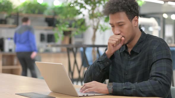 African American Man with Laptop Having Coughing