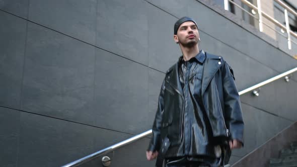 Tracking Shot Side View of Confident Young Gay Man Walking Down Stairs Entering Underground Pass