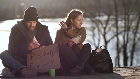 Female Sharing Sandwich and Talking To Homeless