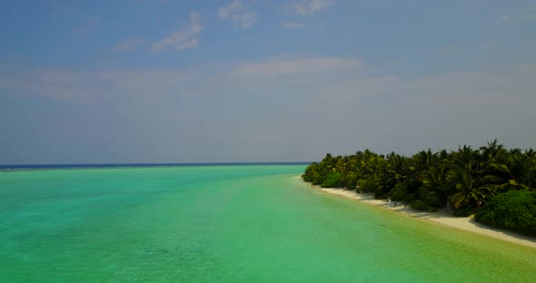 Daytime fly over abstract view of a sunshine white sandy paradise beach and aqua turquoise water bac