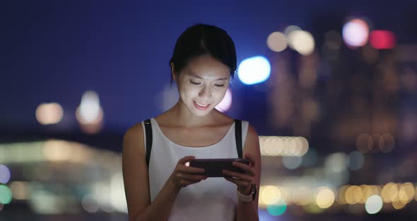 Woman send sms on mobile phone at night