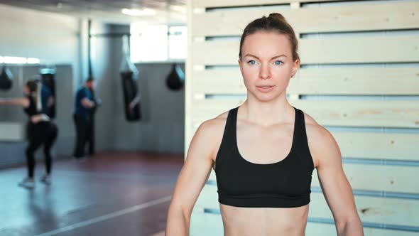 Fitness Girl Lifting Dumbbell in the Gym