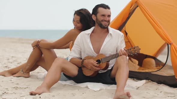 Romantic Couple Near a Tent on the Beach