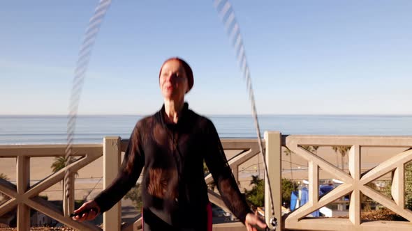 Mature Woman Exercising At The  Beach