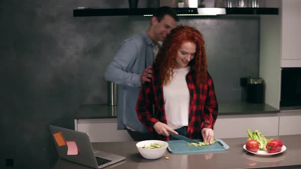 Funny Couple While Cooking Together in Grey Coloured Kitchen Young Active Family Having Fun Laughing