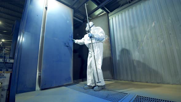 Technician Opens a Garage Unit with Metal Framework