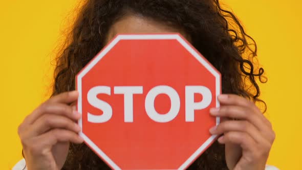 Biracial Girl Holding Stop Sign, Protesting Bullying or Racism, Gun Violence