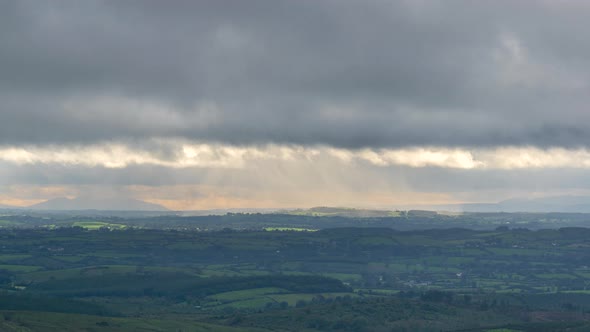 Time lapse of countryside landscape with hills and fields on a cloudy dramatic day in rural Ireland