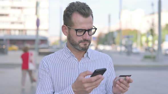 Outdoor Young Adult Man Feeling Upset of Fail Online Shopping