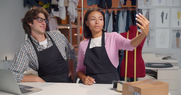 Happy Fashion Store Warehouse Workers Having Fun and Taking Selfie on Smartphone