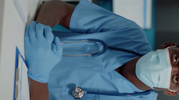 Vertical Video Portrait of Man with Nurse Occupation Looking at Camera