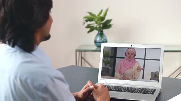 Indian Male Colleague Talking Online with Islamic Female Colleague