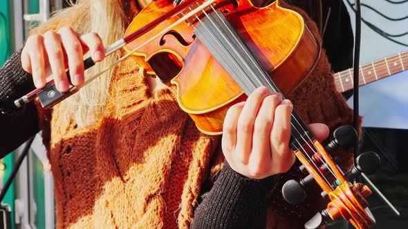 Close Up Footage of Girl with Long Hair Playing Violin Outside in Sunny Weather Music Group