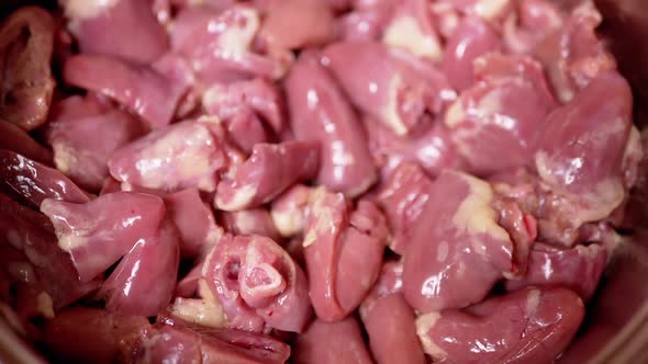 Lots of Fresh Peeled Gutted Raw Chicken Hearts Offal Falling on the Plate