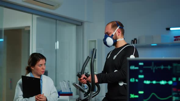 Medical Doctors in Sports Science Lab Measuring Performance Cardiorespiratory