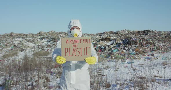 Man Shows Protest Sign a Planet Full of Plastic Against Plastic Landfill