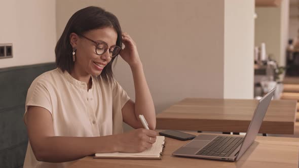 Woman Having Video Conference in Cafe