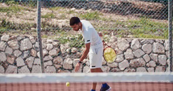 Slow motion of a tennis player serving the ball during a tennis game