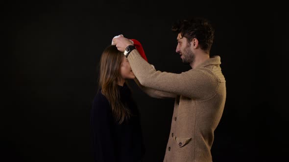 A man putting a hat on a girl's head