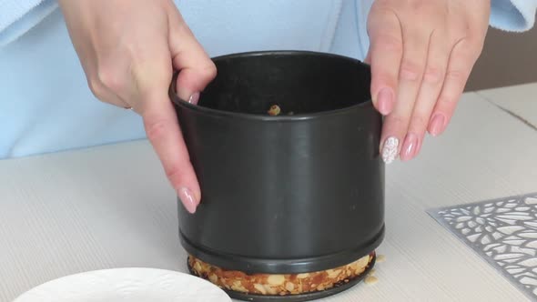 A Woman Takes Out A Prepared Cruffin With Raisins And Candied Fruits From A Baking Dish.