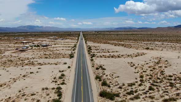 Aerial View of Endless Desert Straight Dusty Asphalt Road in Joshua Tree Park. USA.