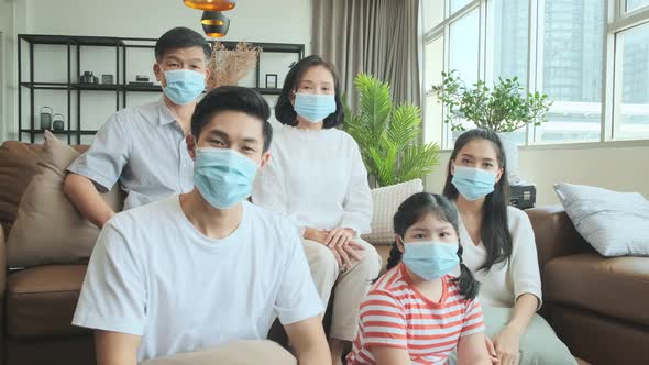 asian family multi generation wearing surgical facial mask stay