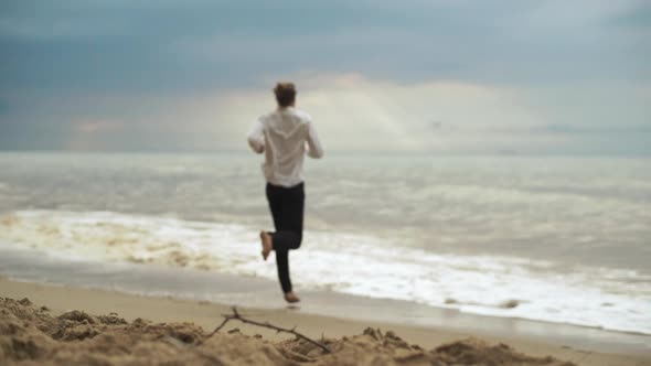 Slim Tall Guy Running Into Sea in Clothes Enjoying Freedom in Slow Motion Connection with Force of