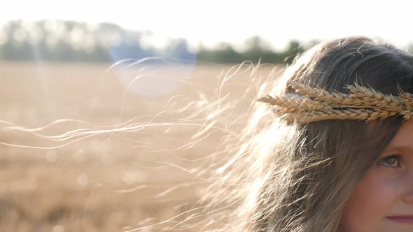 Serious Sad Girl a Child Stands on a Wheat Mown Field