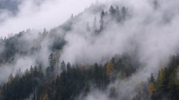 Mystic cloudy and foggy autumn alpine mountain slopes scene. Austrian Lienzer Dolomiten Alps.