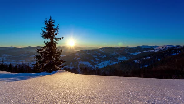 Fog Moving Over the Mountain in Winter with a Starshaped Sky