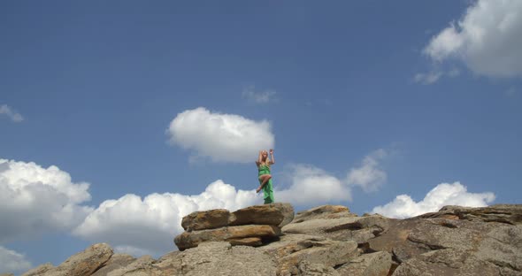 Beautiful Blue Sky with Clouds in the Background of a Woman Dancing