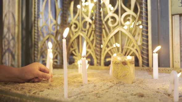 Planting the burning candle in the church.