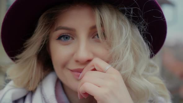 Close-up blue eyed woman looking lovingly on camera.