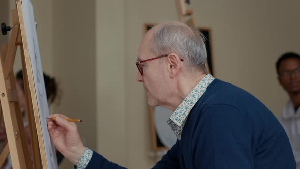 Portrait of Elder Student Using Pencil to Draw Vase Sketch