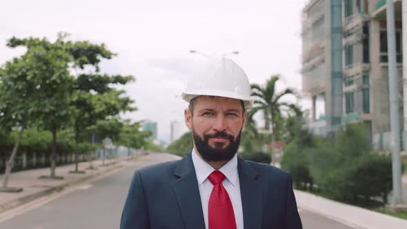 Portrait Senior Industrial Engineer in Business Suit White Safety Helmet Looking Directly Into the