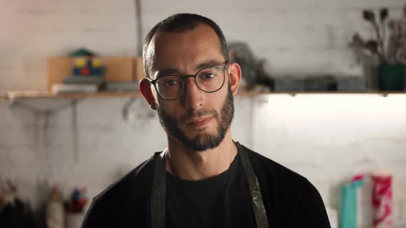 Portrait of a male, close-up: a man in glasses of Arab appearance looks at the camera and smiles.