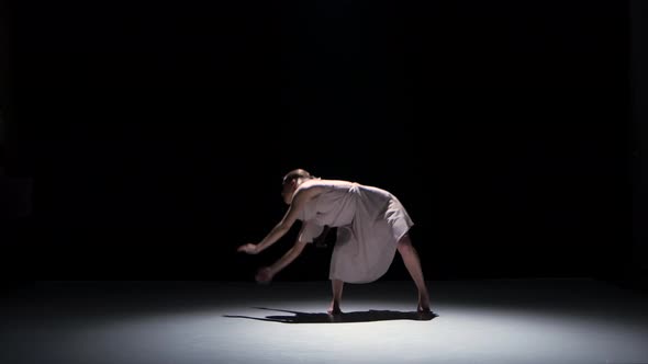 Contemporary Dance Performance of Five Dancers on Black, Shadow