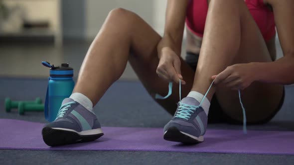 Young Woman in Sportswear Lacing up Sneakers, Getting Ready Before Working Out