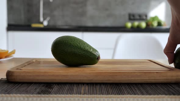 Appetizing Fresh Avocado Lies on a Wooden Tablet