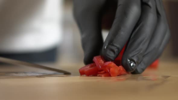 Chef picks up a sliced ​​red pepper with a knife, Apple ProRes slow-mo