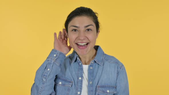 Attentive Indian Woman Listening, Yellow Background 