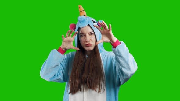 Portrait of a young brunette girl in unicorn costume