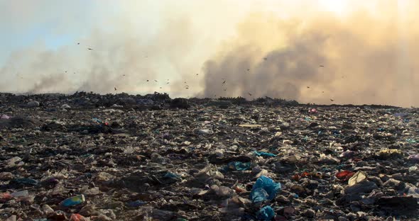 Burning garbage pile in trash landfill