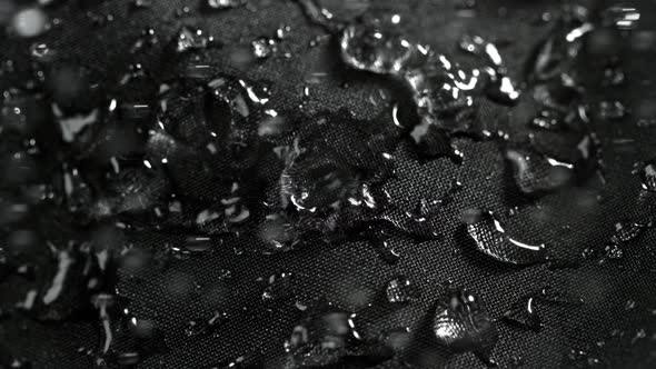 Super Slow Motion Shot of Water Droplets Splashing on Waterproof Cloth at 1000Fps.