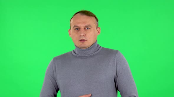 Portrait of Male Looking in Surprise at Camera and Is Shocked By What He Saw. Green Screen