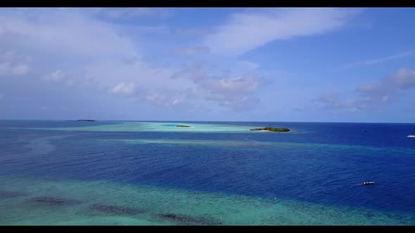 Aerial drone shot travel of idyllic tourist beach adventure by blue sea and white sandy background o