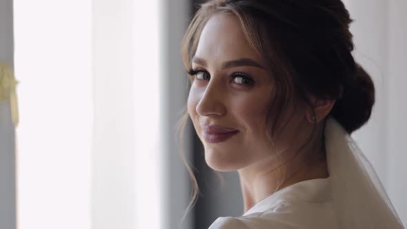 Bride in Boudoir Dress Near Window