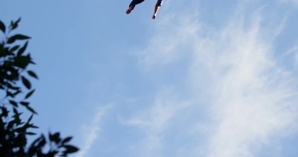 Man relaxing on tight rope